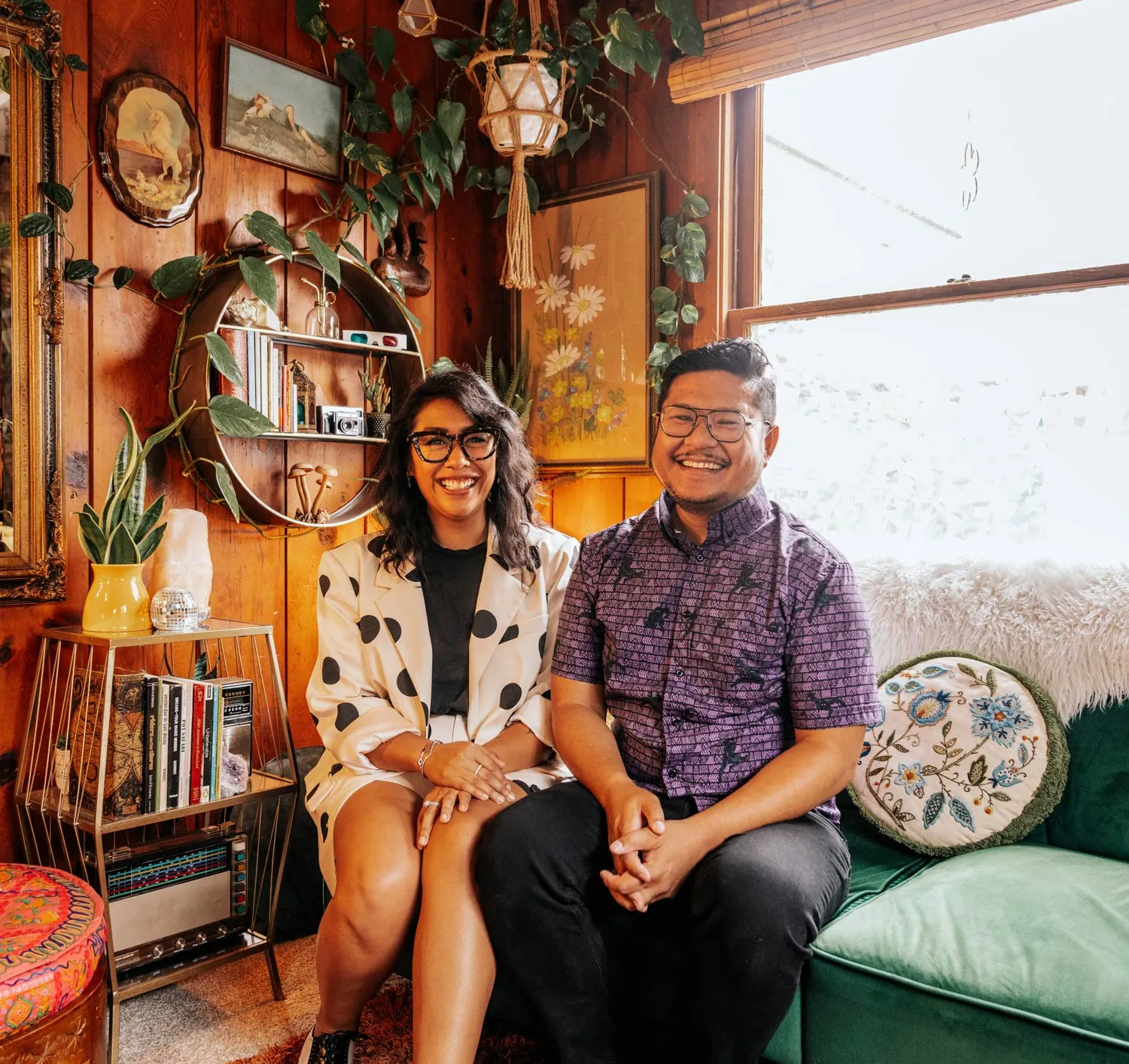 Jess and Nelson sitting on a couch close together